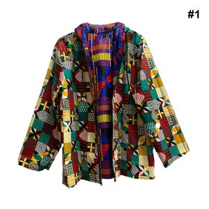 May include: A colorful, patterned jacket with a hood. The jacket features a patchwork design with geometric shapes in red, green, yellow, and blue. The interior lining is a vibrant mix of purple, yellow, and black. The jacket is open, revealing the interior lining.