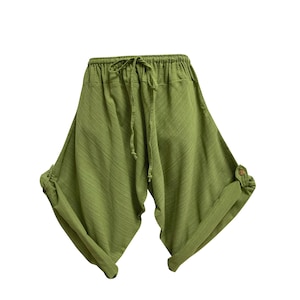 May include: Green harem trousers with a drawstring waist and rolled-up cuffs. The trousers are made of a lightweight fabric and have a relaxed fit. The cuffs are secured with a button. These trousers are a casual style.