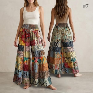 May include: A white tank top paired with wide-leg pants featuring a multi-colored patchwork pattern of various floral and geometric prints. The pants have a high, smocked elastic waistband. The number 7 is visible in the upper right corner.