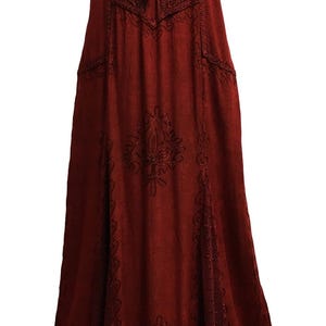 May include: A long, burgundy dress with short sleeves and intricate embroidered details. The dress features a lace-up neckline, pockets, and decorative patterns along the bodice and skirt. The fabric appears soft and flowing, suitable for a casual or bohemian style.