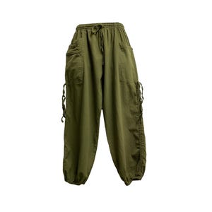 May include: Olive green harem pants with a drawstring waist and side pockets. The pants have a relaxed fit with gathered ankles and decorative ties on the sides. These casual pants are made of a lightweight fabric.
