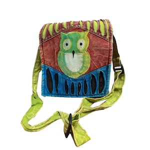 Pode incluir: Uma bolsa de ombro de patchwork verde, vermelho, azul e amarelo com um design de coruja bordado. A bolsa tem uma alça longa ajustável.