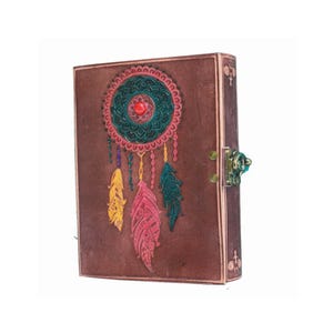 May include: Brown leather journal with a dreamcatcher design embossed on the front cover. The dreamcatcher has colorful feathers and a red gemstone in the center. The journal has a metal clasp.