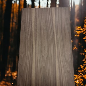 May include: A brown wooden sign with a natural wood grain pattern. The sign is standing upright on a tree stump in a forest setting.