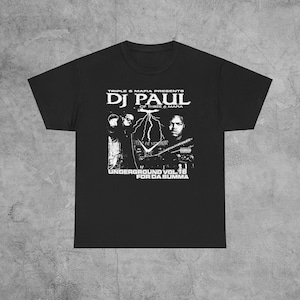 May include: Black t-shirt with a white graphic print of DJ Paul, of Three 6 Mafia, with the text "Triple 6 Mafia Presents DJ Paul of Three 6 Mafia Underground Vol 16 For Da Summa".