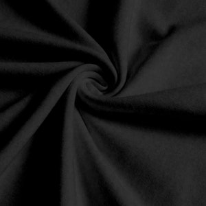May include: Black fabric with a soft, smooth texture. The fabric is folded and draped, creating a smooth, flowing look.