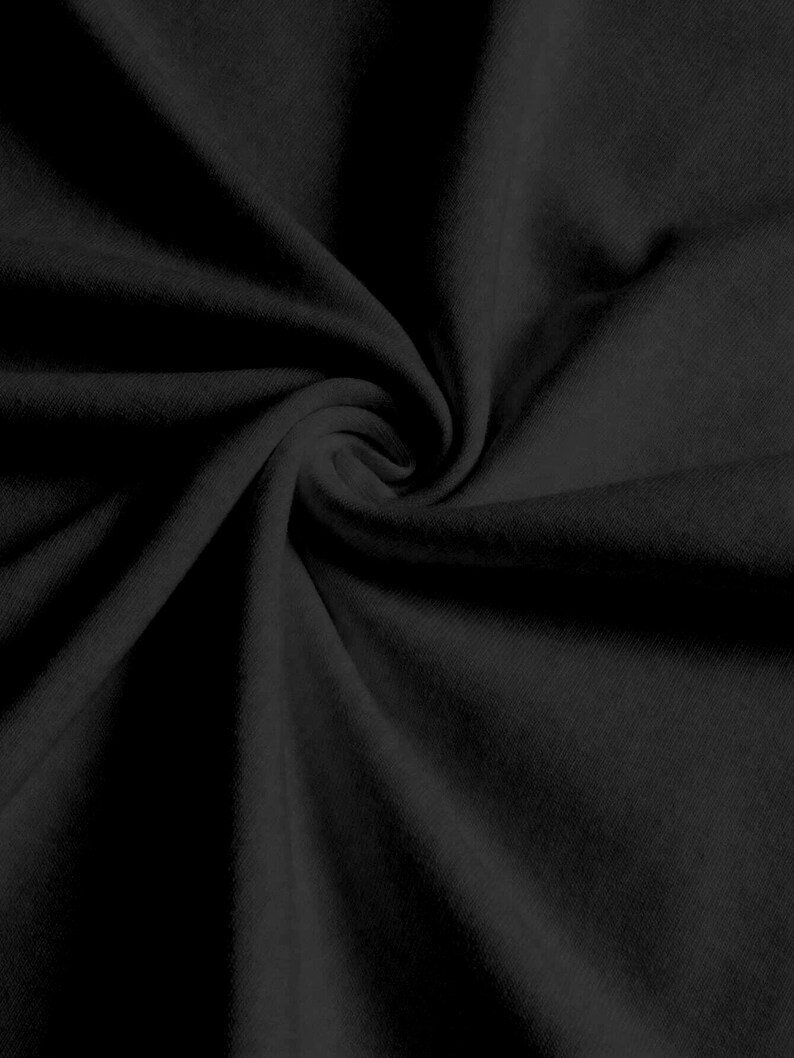 May include: Black fabric with a soft, smooth texture. The fabric is folded and draped, creating a smooth, flowing look.