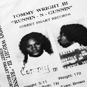 May include: Black and white mugshot style image of a person with the text "Tommy Wright III - "Runnin-N-Gunninin" Street Smart Records" above the image. The text "Tommy III" is below the image. The text "Height: 5-11, Birth: TN, Weight: 170, Eyes: Brown" is below the image.
