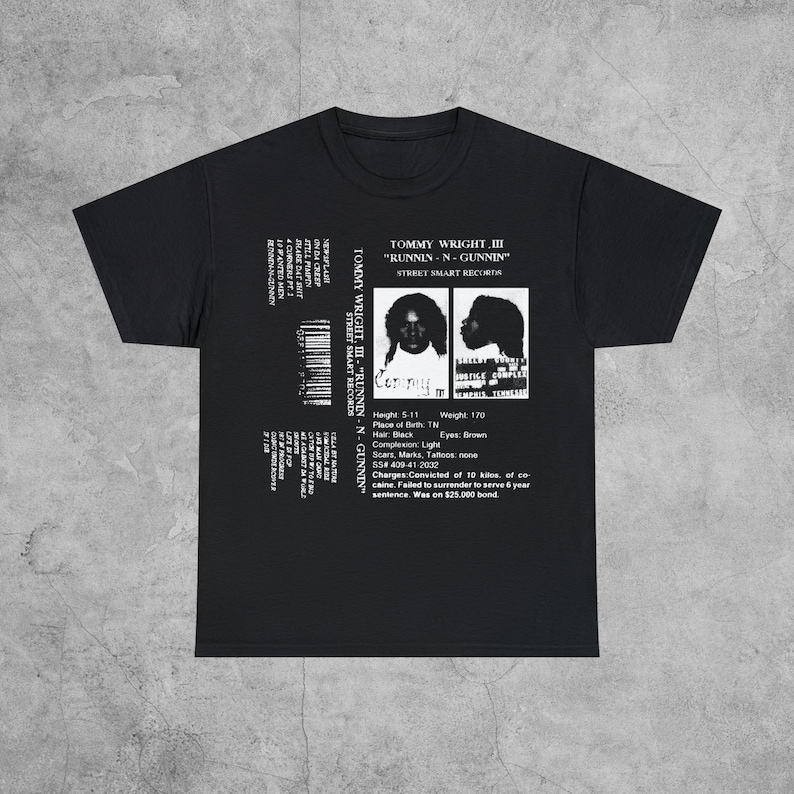 May include: Black and white graphic t-shirt featuring a cassette tape design with a mugshot of Tommy Wright III and the text "Tommy Wright III "Runnin-N-Gunnin" Street Smart Records".
