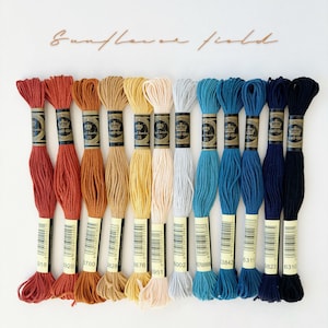 May include: A set of 12 embroidery floss spools in various shades of orange, yellow, beige, blue, and navy. The spools are labelled with the brand name "all4bry" and the numbers 918, 1920, 3780, 3828, 3676, 6002, 6311, 3842, 823, 6310, 951.