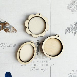 May include: Three wooden embroidery hoops with a natural finish. The hoops are round and oval shaped. The hoops are perfect for crafting and creating unique projects.