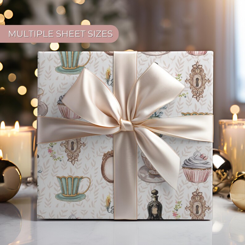 wrapping paper with whimsical vintage tea party illustrations including teacups, cupcakes, candlesticks, keys, and perfume bottles in pastel tones