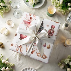 Elegant nutcracker-themed Christmas wrapping paper featuring ballerinas, crowns, trees, and ornaments in a festive, vintage style.