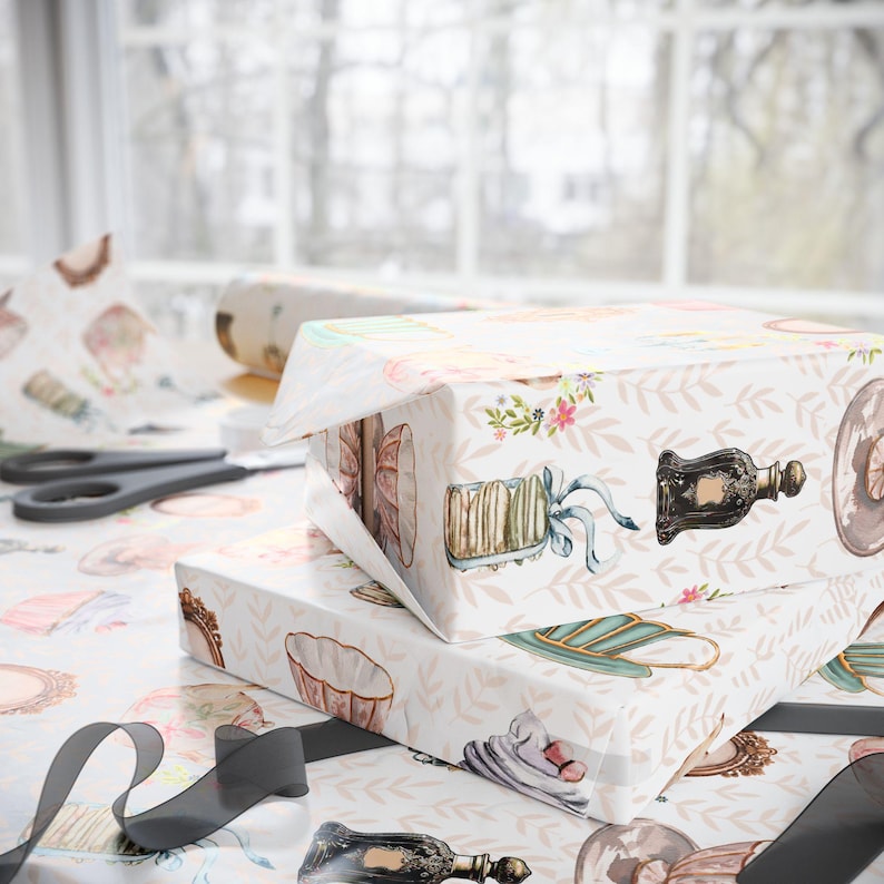vintage tea party wrapping paper featuring teacups, cupcakes, perfume bottles and keys, wrapped with taupe ribbon, ideal for elegant gifts