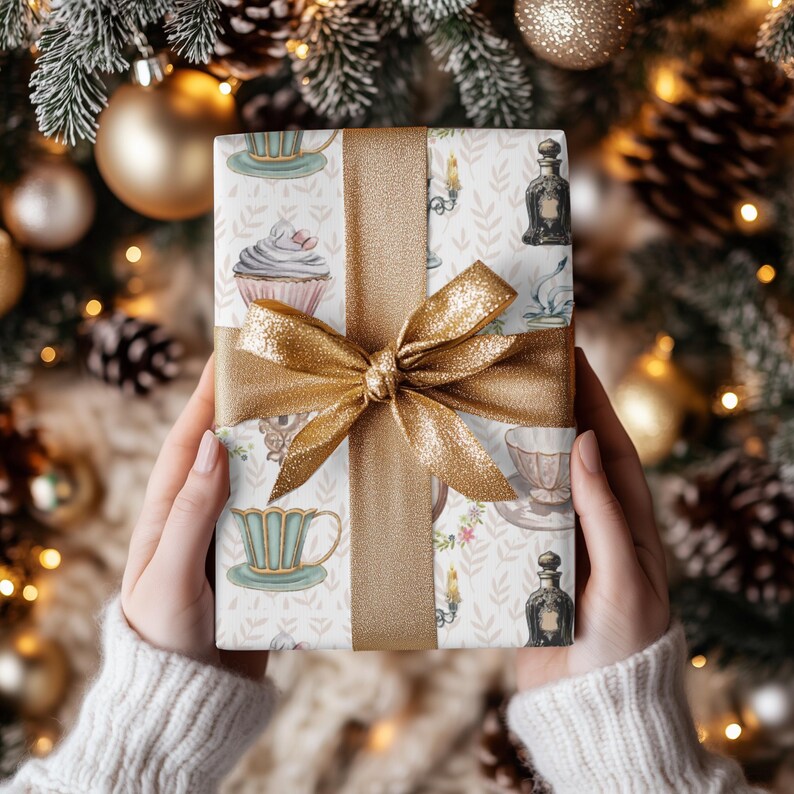 wrapping paper with whimsical vintage tea party illustrations including teacups, cupcakes, candlesticks, keys, and perfume bottles in pastel tones