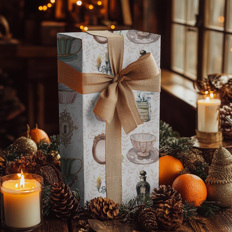 wrapping paper with whimsical vintage tea party illustrations including teacups, cupcakes, candlesticks, keys, and perfume bottles in pastel tones