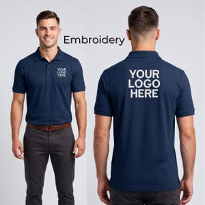 May include: A navy blue polo shirt featuring short sleeves, a collar, and a button placket. The front left chest displays the text YOUR LOGO HERE, and the back features the same text in a larger size. The word Embroidery is visible above.