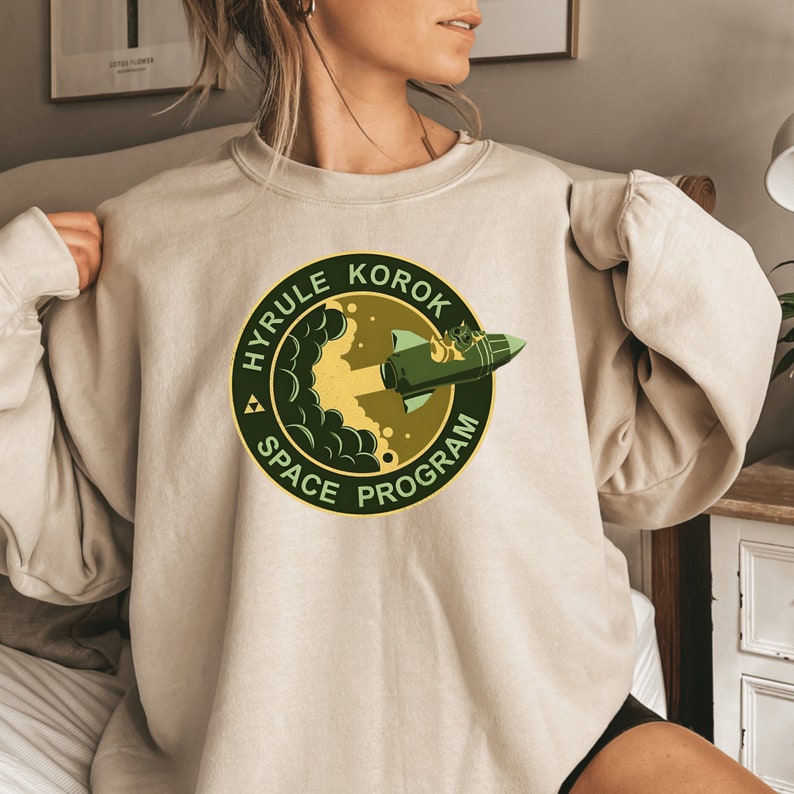 a woman wearing a sweatshirt with a logo on it