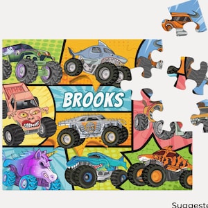 May include: A 10" x 18" puzzle featuring monster trucks with various designs, including a shark, unicorn, and tiger. The puzzle has 30 pieces and the name "Brooks" is printed on the puzzle.
