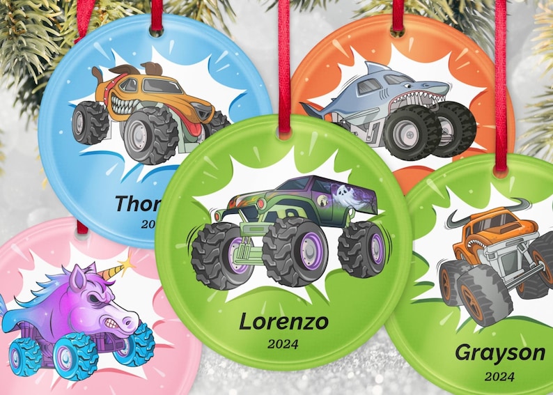 May include: Set of six round Christmas ornaments with monster truck designs. Each ornament features a different monster truck illustration in vibrant colors, with names and the year 2024 or 2020 printed below the image. Red ribbons are attached for hanging.