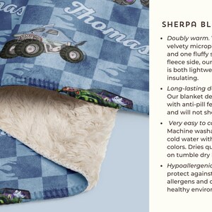 May include: A blue and white checkered sherpa blanket with a monster truck design and the name "Thomas" printed on it. The blanket is soft and fluffy, and it is perfect for keeping warm on cold nights.