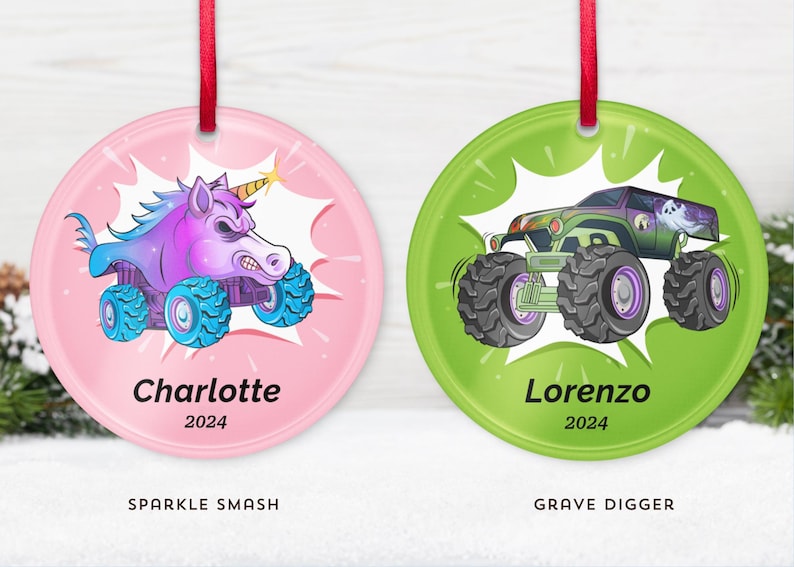 May include: Two round Christmas ornaments with red ribbons. One pink ornament features a cartoon unicorn monster truck with the name "Charlotte" and the year "2024". The other green ornament shows a monster truck with the name "Lorenzo" and the year "2024".