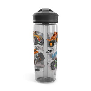 May include: A clear water bottle with a black lid and straw. The bottle features colorful illustrations of monster trucks in orange, green, and yellow, with the words "GO!!!" and "JAM".