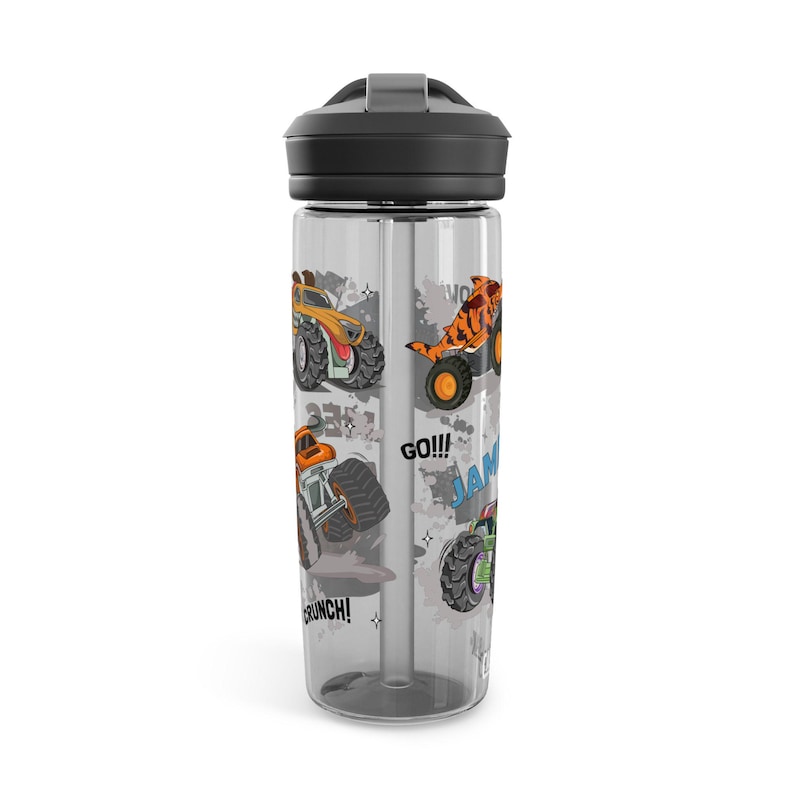 May include: A clear water bottle with a black lid and straw. The bottle features colorful illustrations of monster trucks in orange, green, and yellow, with the words "GO!!!" and "JAM".