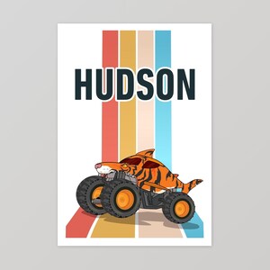 May include: A colorful retro-style poster with a monster truck design. The truck is orange and black with a tiger stripe pattern. The truck is driving on a rainbow-colored background. The name "HUDSON" is printed in black at the top of the poster.