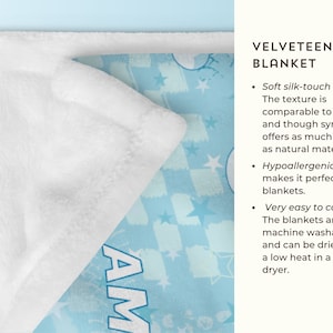 May include: A white velveteen minky blanket with a blue and white checkered pattern and stars. The blanket has the word "AM" printed on it.