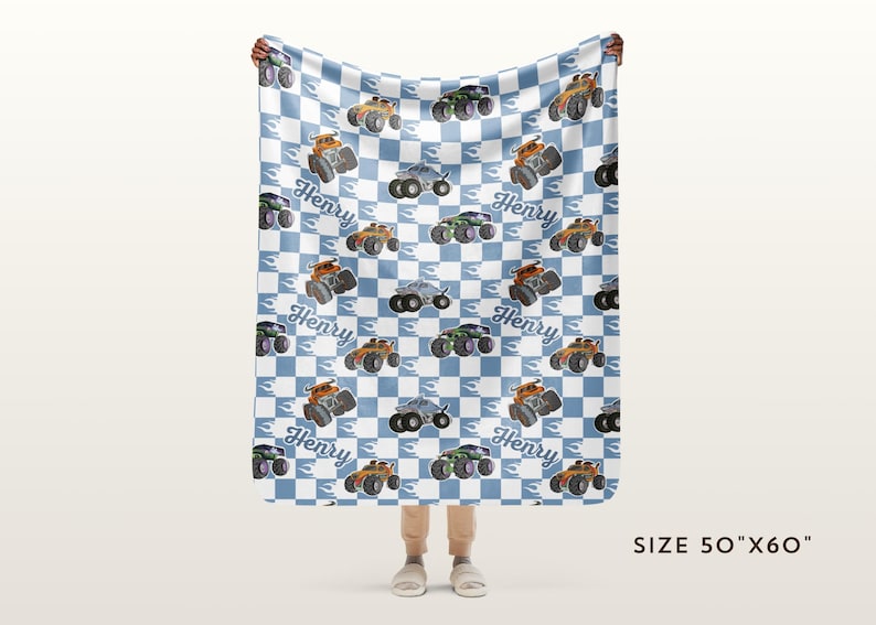 May include: A blue and white checked fleece blanket with a monster truck pattern. The trucks are orange, green, and blue. The blanket has the name "Henry" repeated throughout. The blanket is 50 inches by 60 inches.