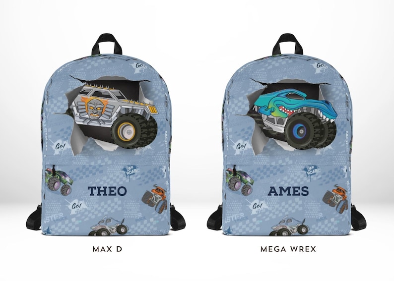 May include: Two blue backpacks with monster truck designs. One features a silver truck with the name "THEO" and the other a blue truck with the name "AMES". Both have black straps and handles, with "MAX D" and "MEGA WREX" printed below.
