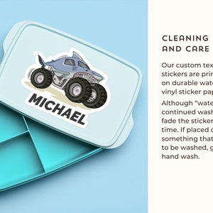 May include: A light blue lunchbox with a removable lid. The lid has a sticker of a blue monster truck with the name "MICHAEL" printed on it. The lunchbox has four compartments.