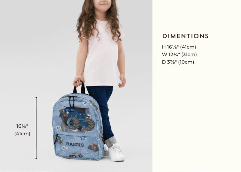 May include: A light blue backpack with a monster truck design. The backpack is 16 5/8" (41cm) high, 12 1/4" (31cm) wide, and 3 7/8" (10cm) deep. The word "BANKS" is printed on the backpack.