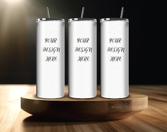May include: Three white stainless steel tumblers with black lids and straws. The tumblers are on a wooden stand. The text "YOUR DESIGN HERE" is printed on each tumbler.