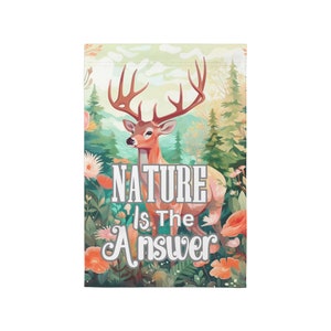 May include: A colorful garden flag with a deer in the center and the text "NATURE is the Answer". The deer is brown with large antlers and is surrounded by green leaves and flowers.