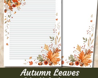 May include: Two sheets of printable stationery featuring watercolor autumn leaves, acorns, and berries. One sheet has horizontal black lines, while the other is blank. The design includes orange, brown, and green foliage accents in the corners.