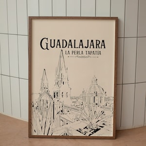 May include: A black and white illustration of the Guadalajara skyline, featuring a church with two towers and a dome. The text "GUADALAJARA LA PERLA TAPATÍA" is printed above the illustration.