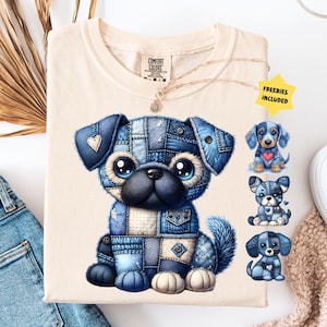 May include: Cream-colored t-shirt featuring a patchwork denim dog graphic with large eyes and a fluffy tail. The shirt includes the text "FREEBIES INCLUDED" on a yellow star-shaped sticker. A pair of blue jeans and a necklace are also visible.