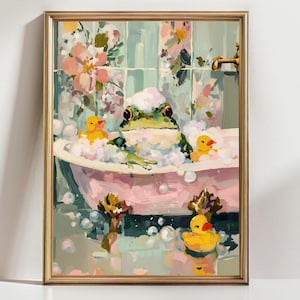 May include: A framed art print depicts a green frog relaxing in a pink bathtub filled with bubbles. Two yellow rubber duckies float in the water. The background features floral wallpaper and a gold faucet.