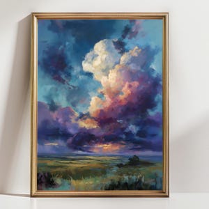 May include: A framed landscape painting featuring a dramatic sky filled with white, purple, and orange clouds. The artwork depicts a field of green and yellow grass under a vibrant, colorful sky. The frame is gold.