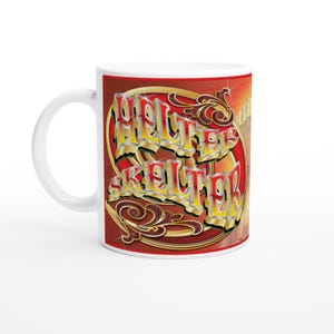 May include: White ceramic mug with the words "HELTER SKELTER" in gold and yellow lettering, set against a red and brown background with decorative swirls. The mug has a standard handle.