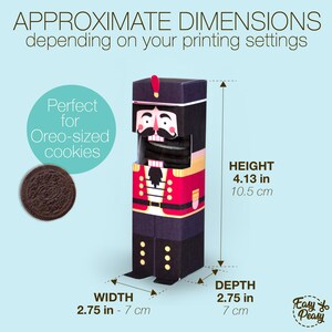 May include: A paper nutcracker-shaped box with a red and black uniform design. The box is 4.13 inches (10.5 cm) tall, 2.75 inches (7 cm) wide, and 2.75 inches (7 cm) deep. The text on the box says "Perfect for Oreo-sized cookies."