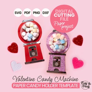 May include: A digital cutting file for a Valentine's Day paper project, featuring candy machine templates. The red and purple machines are filled with marshmallows and surrounded by heart decorations. Text includes "SVG PDF PNG DXF" and "Valentine Candy Machine".