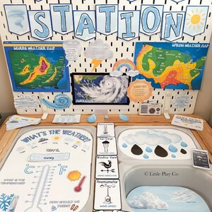 May include: A weather station educational display featuring a pegboard with the text WEATHER STATION, maps, and weather icons. Below, a play surface includes a thermometer chart, weather instrument cards, and cloud illustrations.