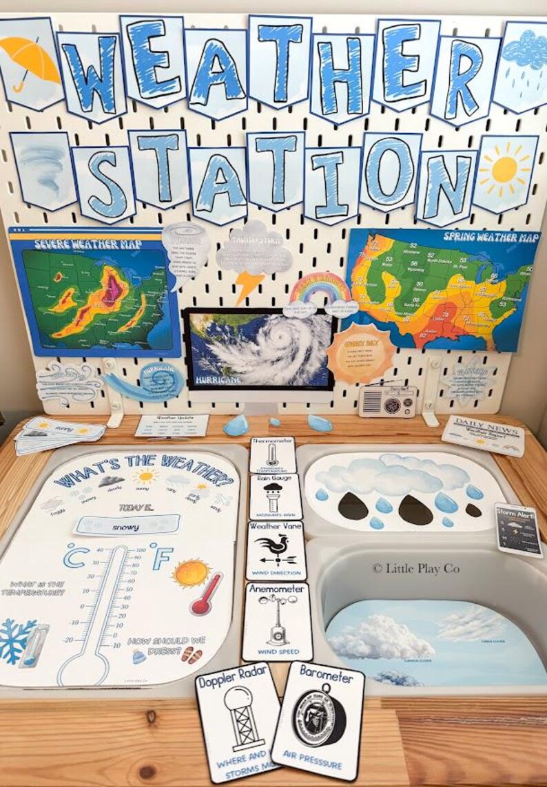May include: A weather station educational display featuring a pegboard with the text WEATHER STATION, maps, and weather icons. Below, a play surface includes a thermometer chart, weather instrument cards, and cloud illustrations.
