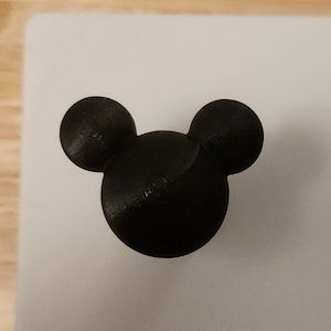 May include: Black plastic Mickey Mouse head ornament.