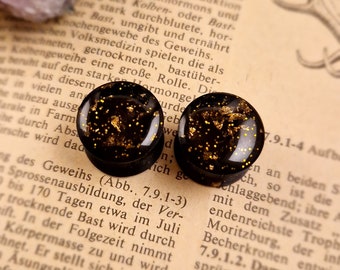 a pair of ear studs | 1001 Nights | Plugs Tunnel