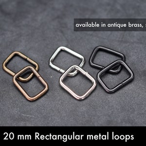 May include: Four 20 mm rectangular metal loops in antique brass, silver, and black.