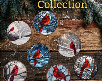 May include: A collection of round ornaments featuring red cardinal birds in winter scenes. The ornaments have a stained-glass effect, with the text "Cardinal Collection" in gold lettering at the top.
